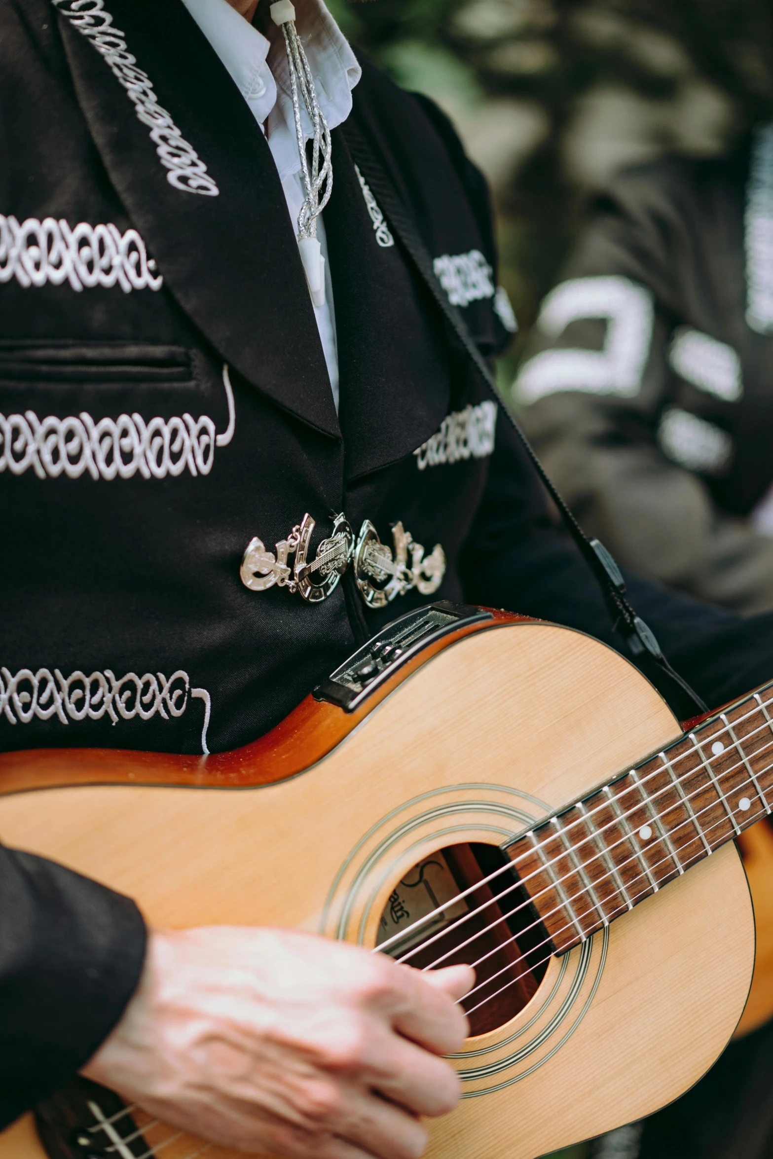 close up of a man playing a guitar