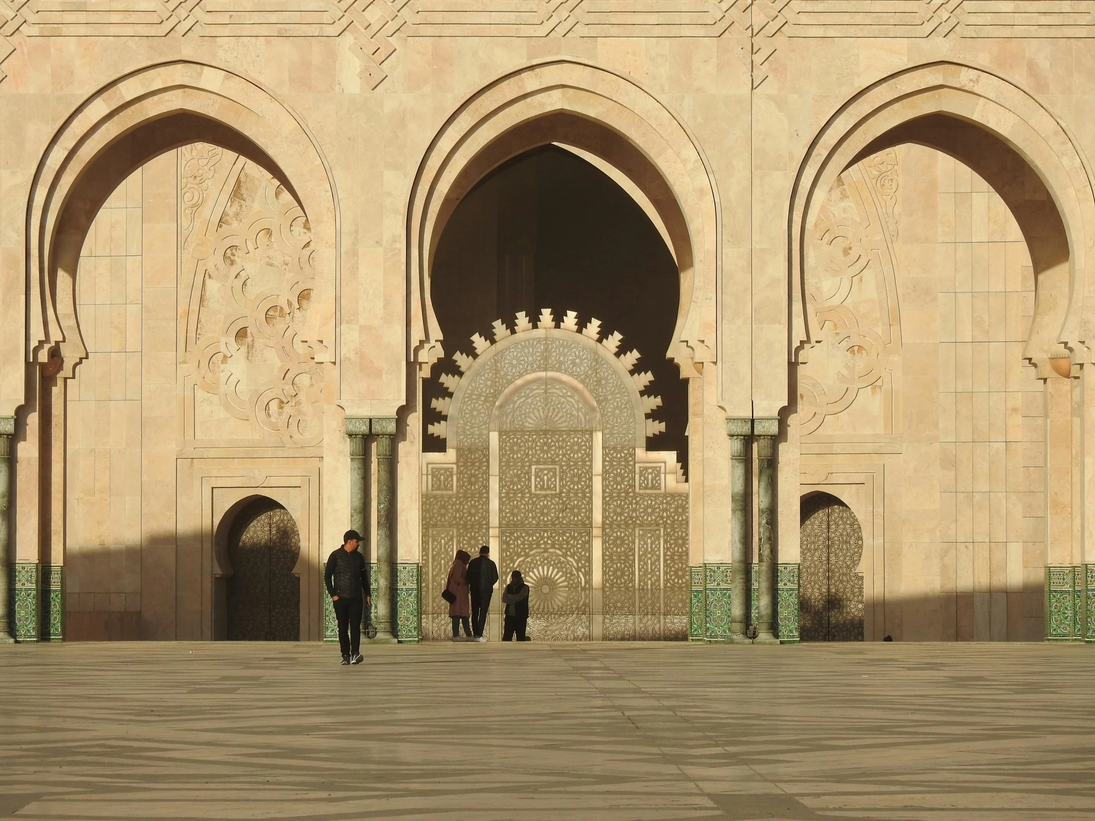 some people in the stone courtyard area of an old building