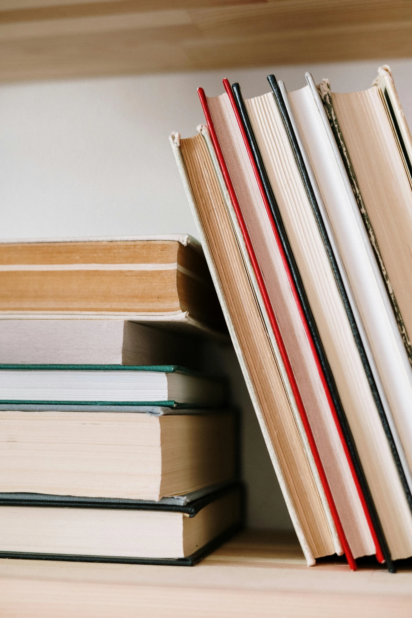 there are several books placed on a book shelf