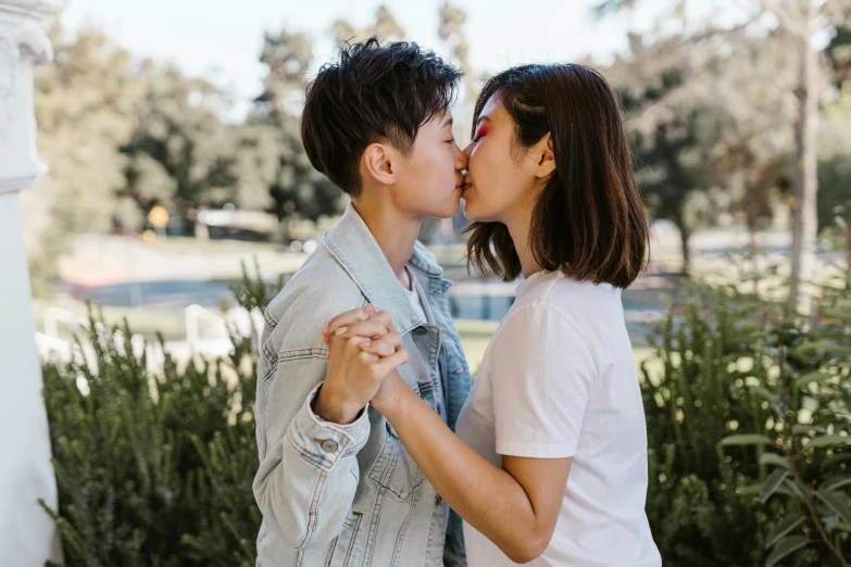 two people kissing each other on the forehead