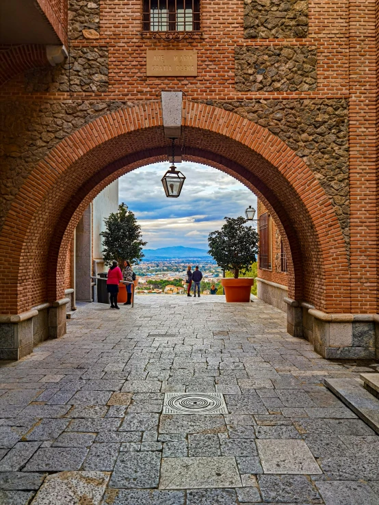 a wide brick pathway that leads to a light