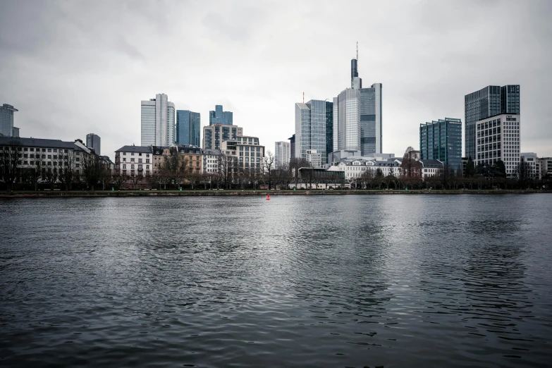 a lake with some buildings in the distance