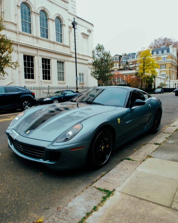 the sports car is parked in front of the building