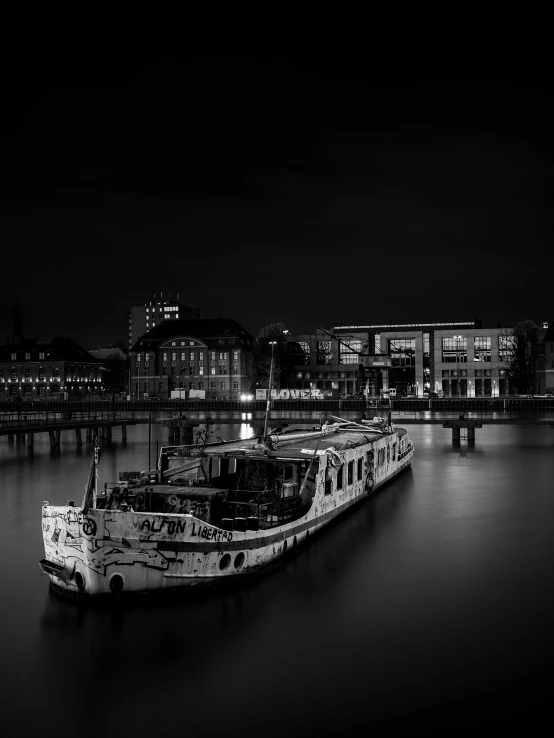 a black and white po of two boats moored at a dock