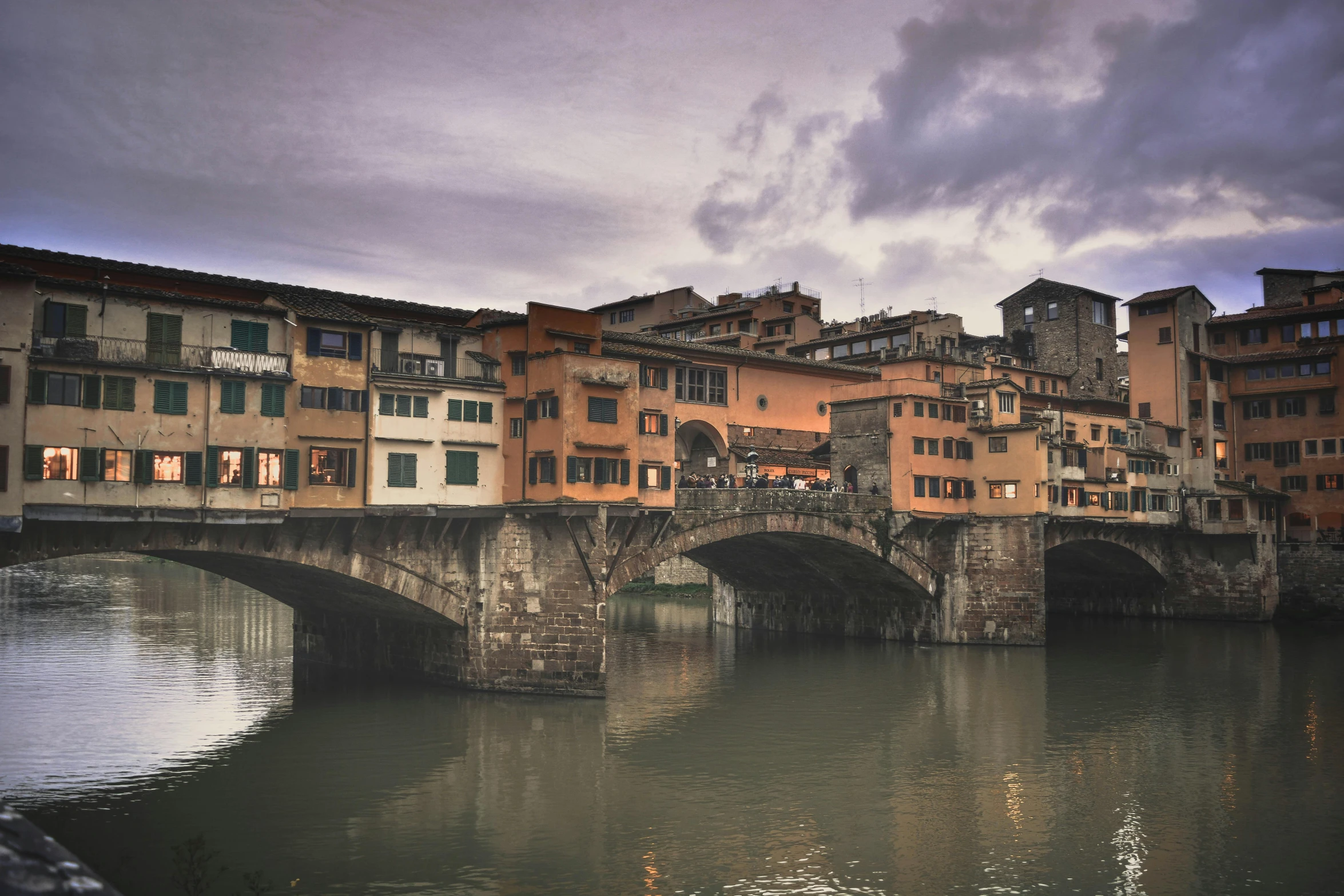 many buildings with a bridge over the water