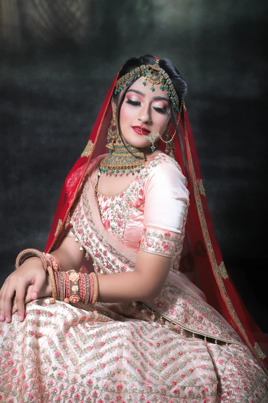 a woman wearing a traditional indian bridal outfit
