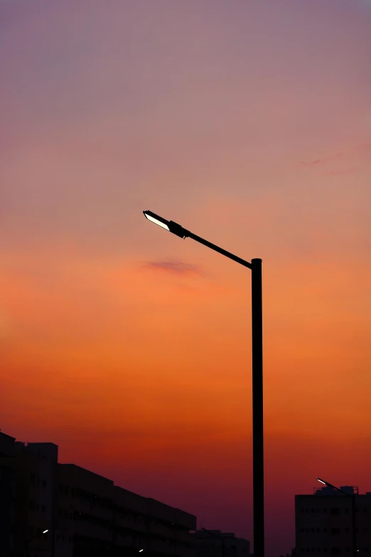 a street lamp next to a tall building