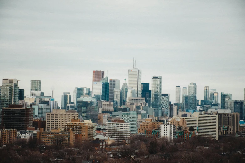 city buildings in the middle of a cloudy sky