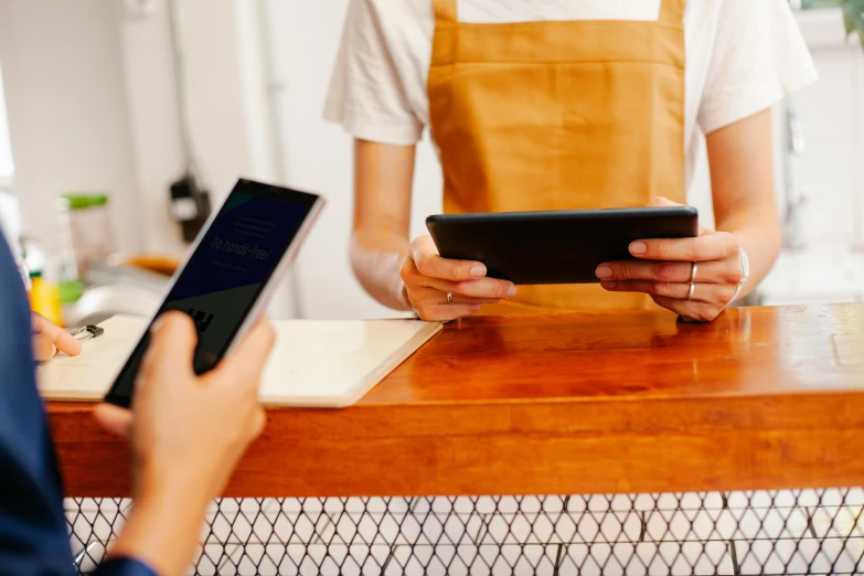 a person in a kitchen is working on a cell phone