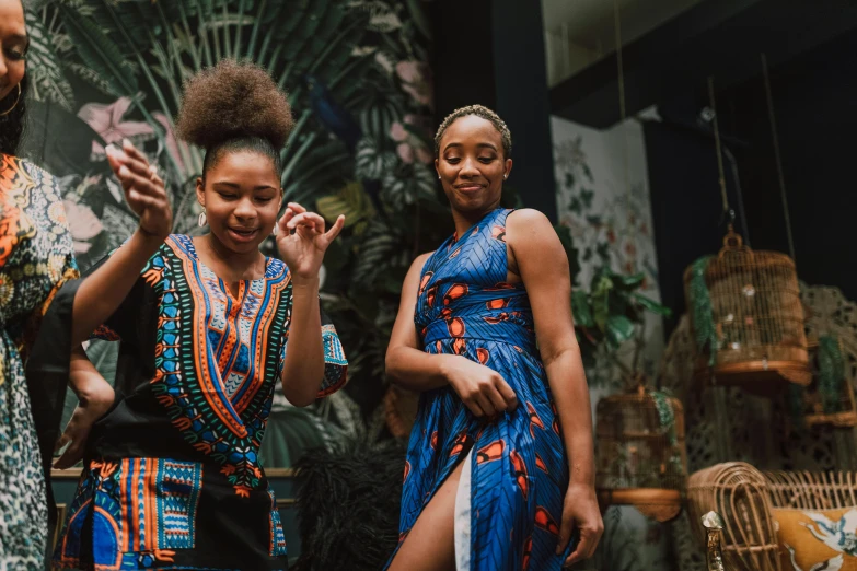 three women standing beside each other wearing matching dress