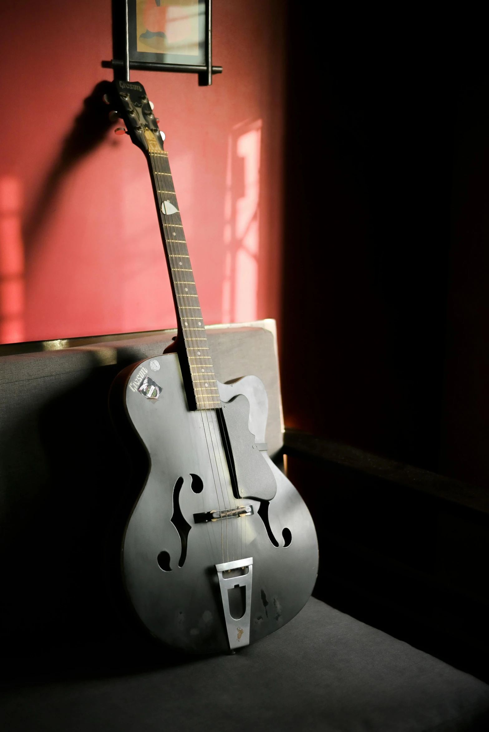 a guitar sitting on top of a wall