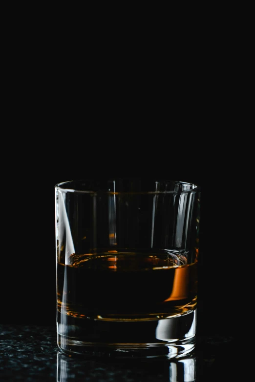 a glass of alcohol with one in the foreground