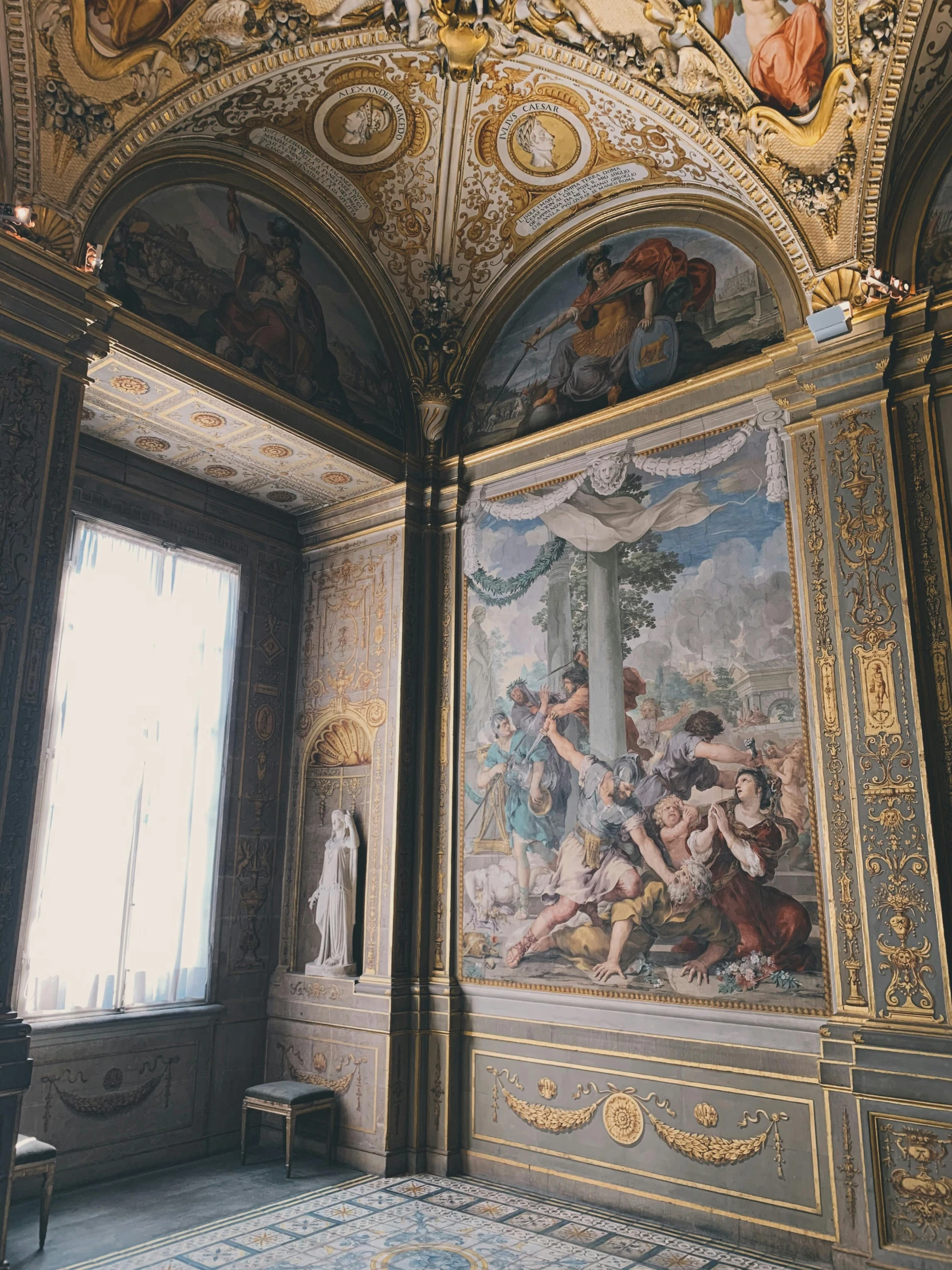 an ornate room with a painting on the ceiling