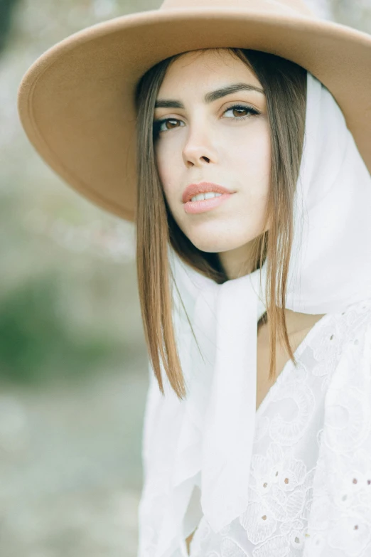 a girl in a white shirt wearing a brown hat