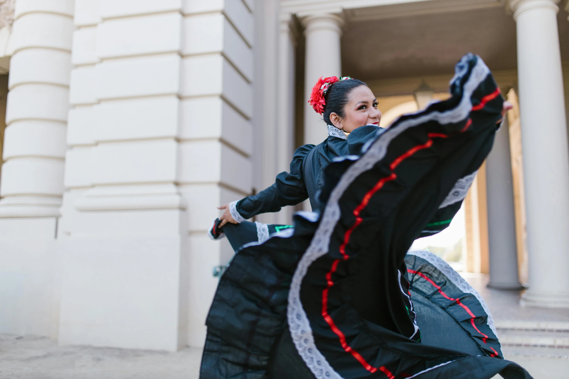 woman in black jacket riding a large dragon bag