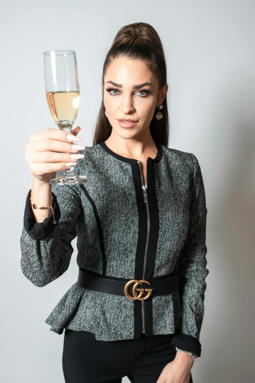 a woman standing up holding a glass of wine