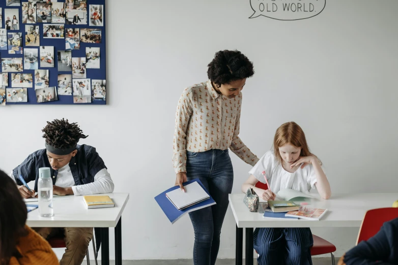 a group of s sitting at desks studying