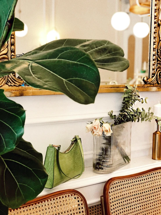 a mirror and some wicker chairs with flowers on the table