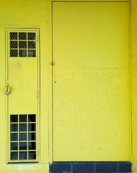 a yellow door and window with small windows