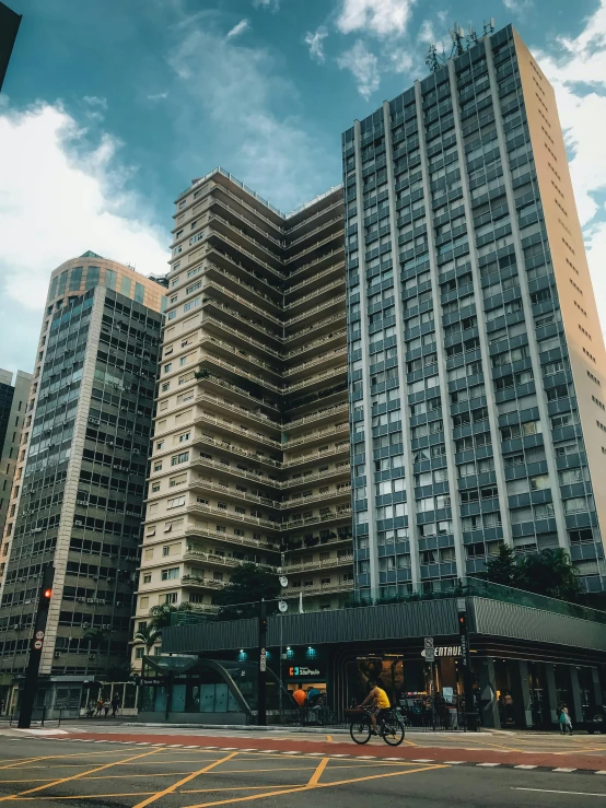 the city street scene features tall buildings with one green light