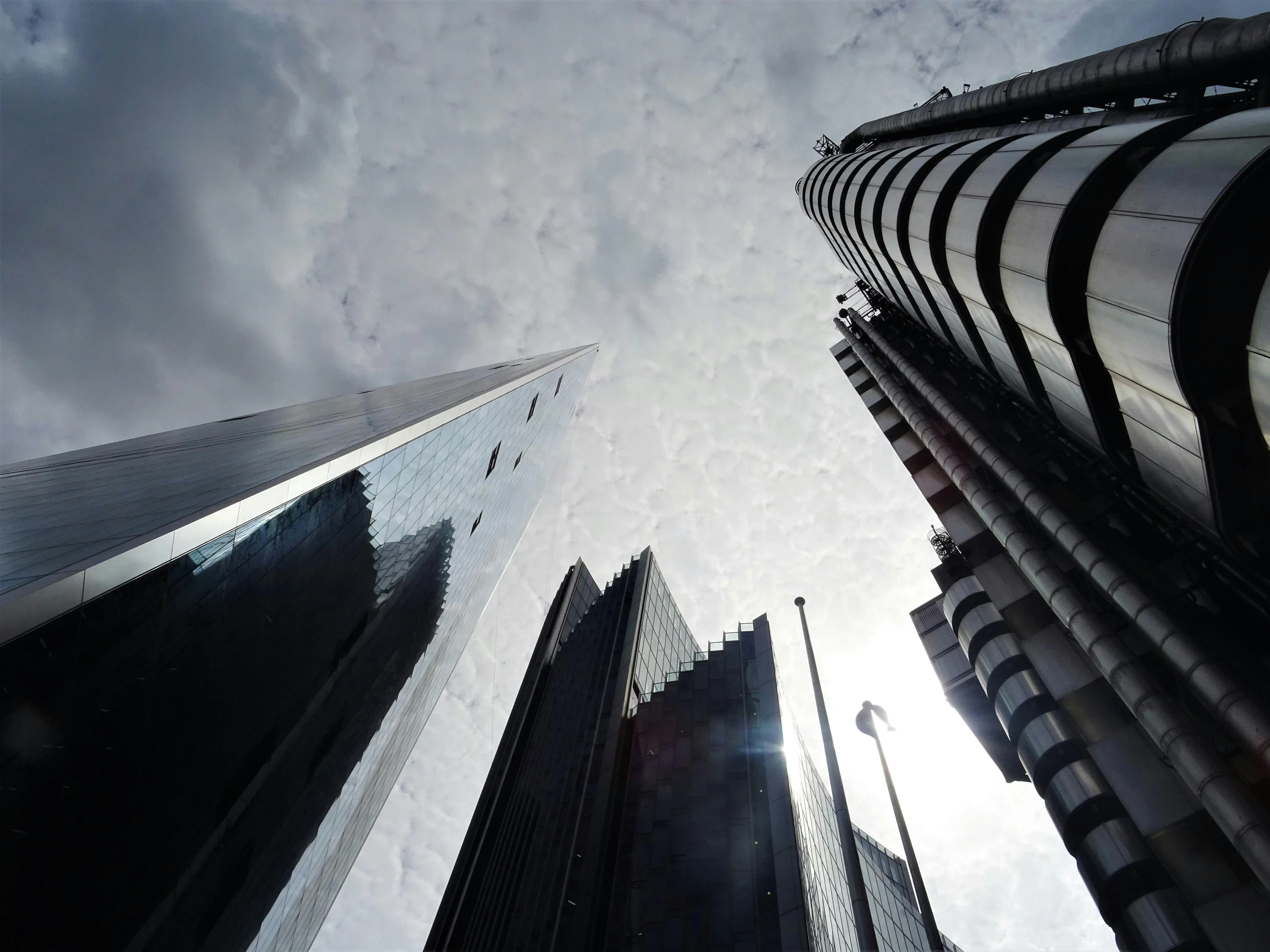 two tall buildings standing under cloudy skies