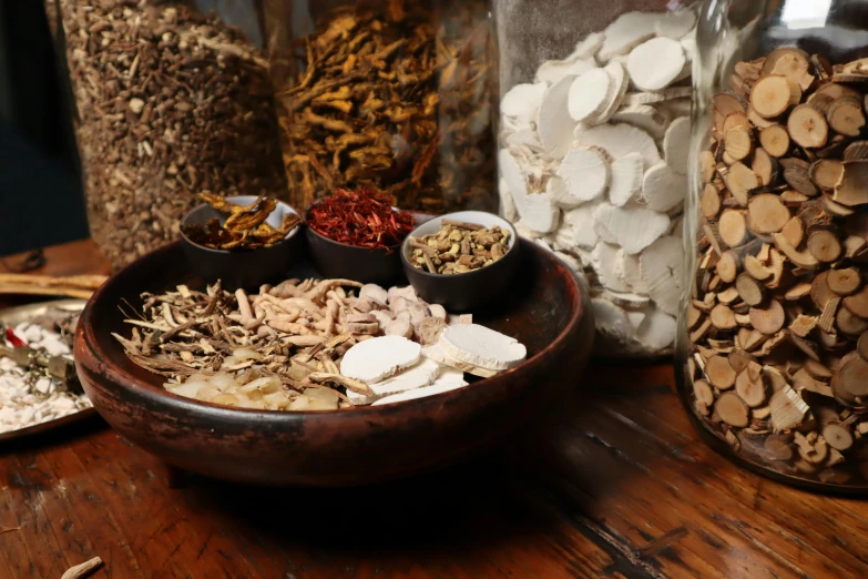 bowls and jars on a wooden table full of food