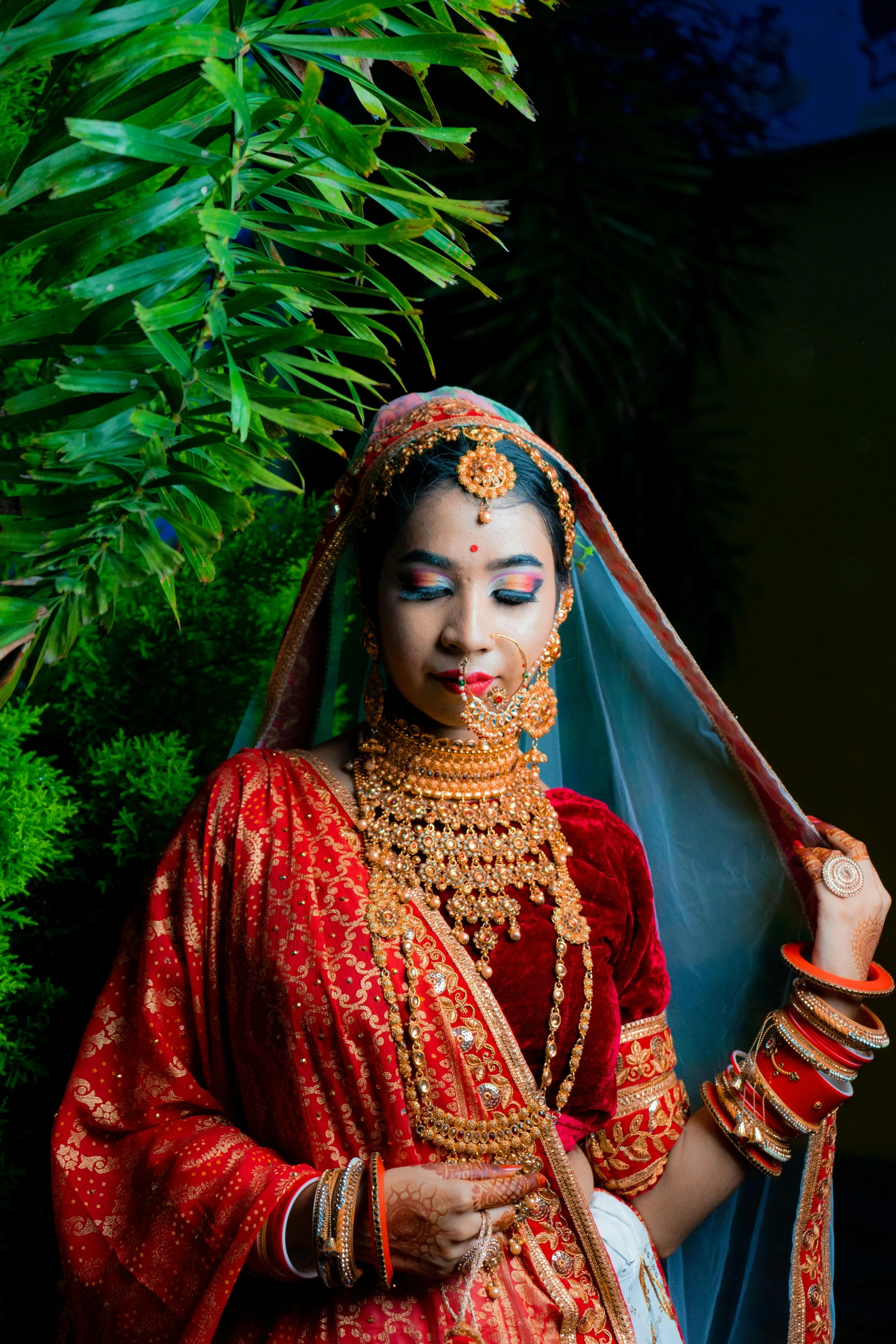 an indian bride in traditional dress and makeup