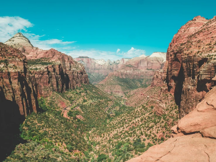 the view of mountains, canyons and valleys below