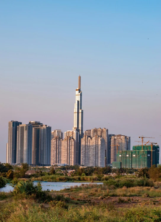 a skyline of tall buildings are shown near a river