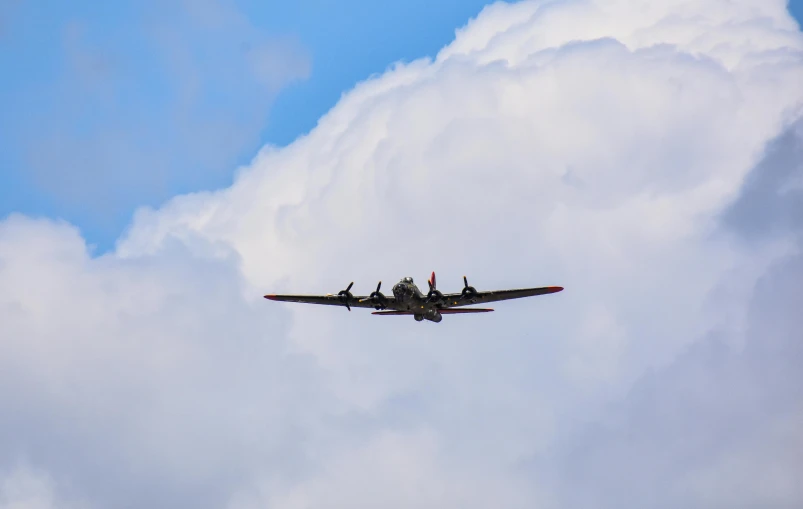 there is a plane flying on the blue sky