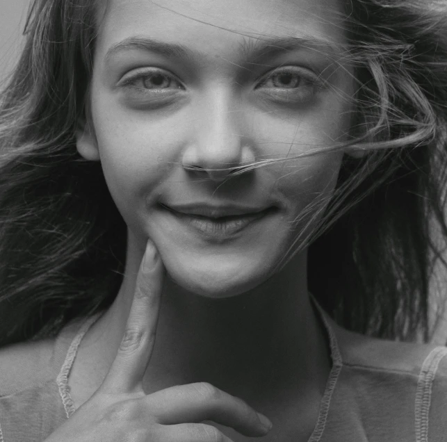 a woman is posing with her nose mustache