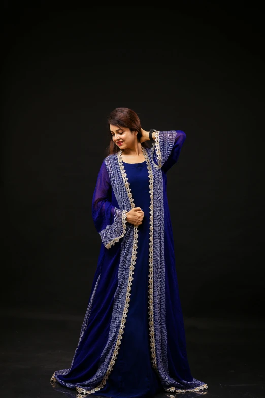 woman in blue and white suit with black background