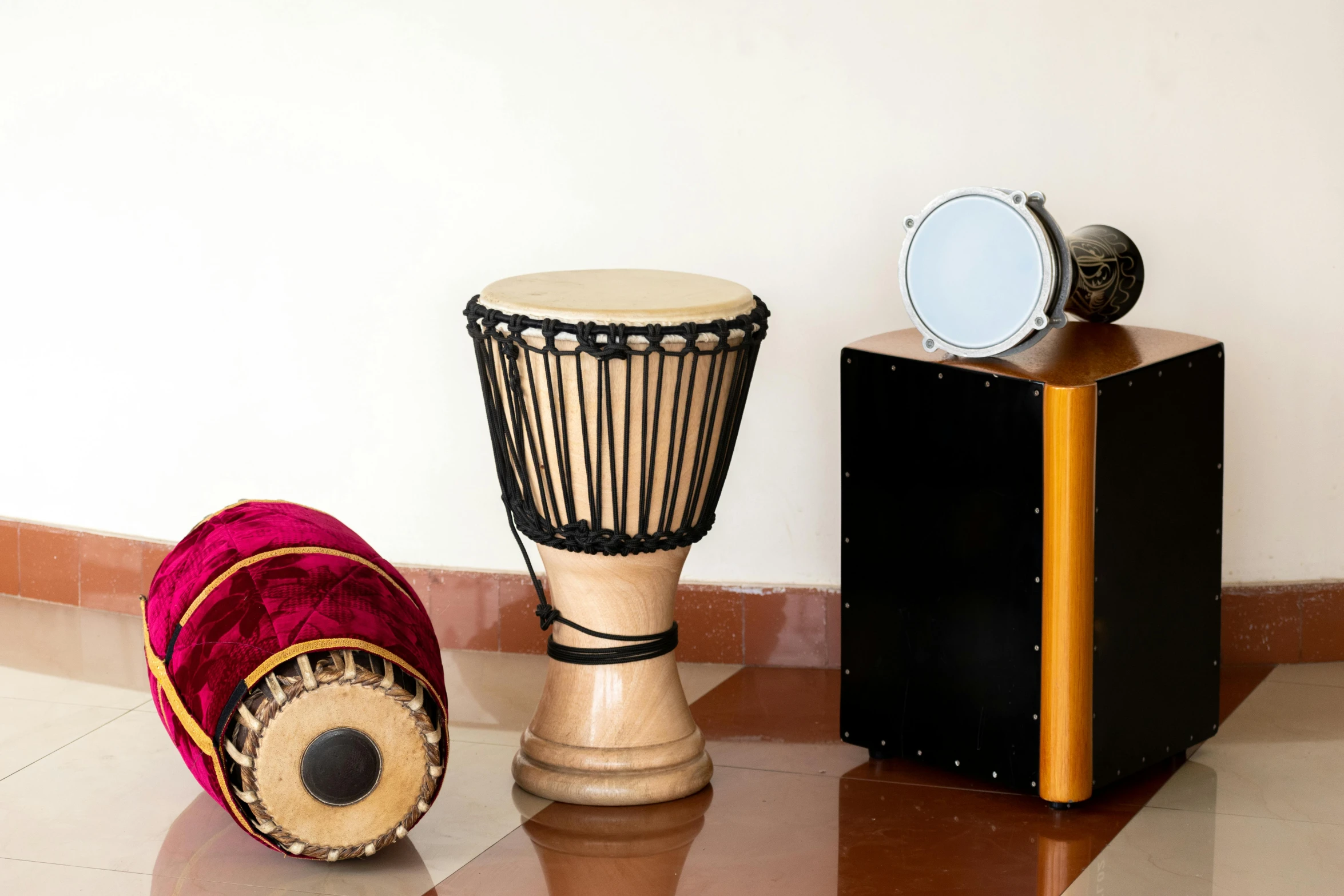 two musical instruments on a shiny surface next to a leather case