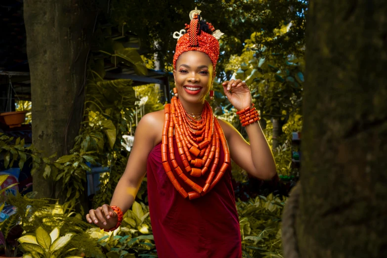 woman dressed in red dress with beads around her neck