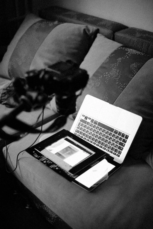 a picture of two laptops on the sofa