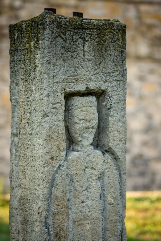 a grey monument with a man face on it