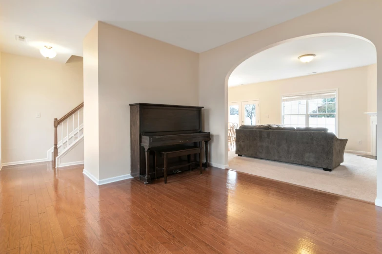 a room with white walls and hard wood floor