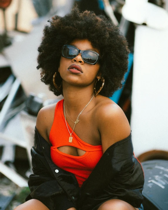 a woman with an orange shirt and sunglasses