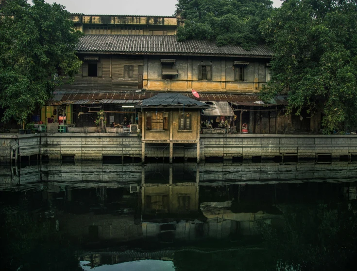 an old building with a boat dock in the foreground