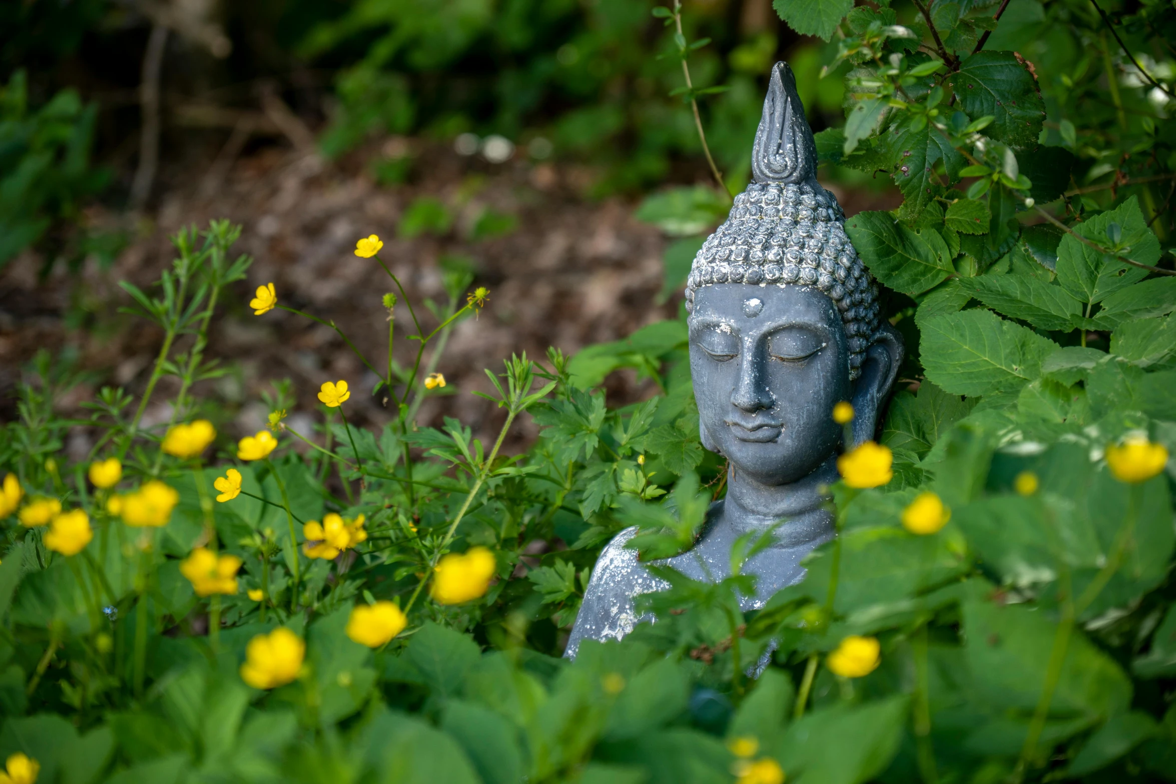 a small statue is sitting on some green grass