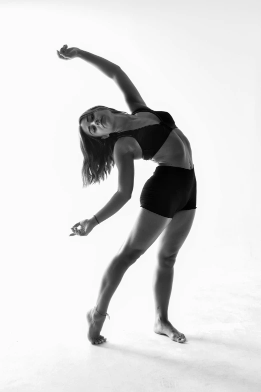 a woman in a leotard is dancing on a white background