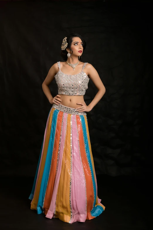 a beautiful young woman posing in a colorful skirt
