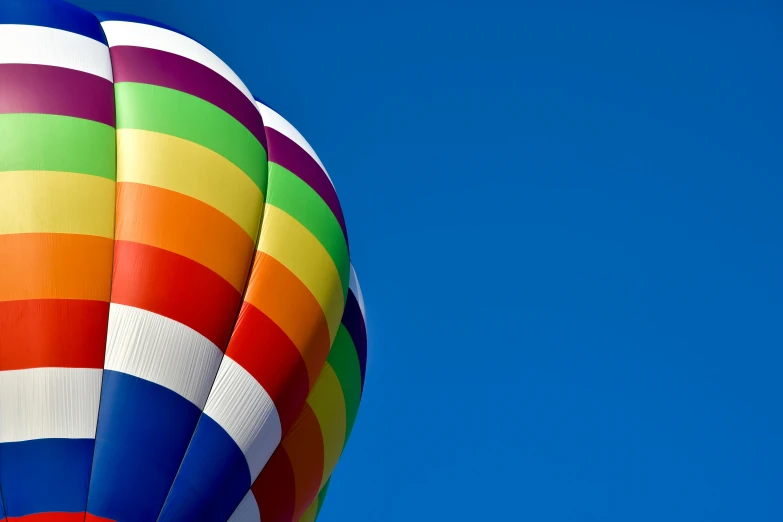 the tail of a  air balloon against a blue sky