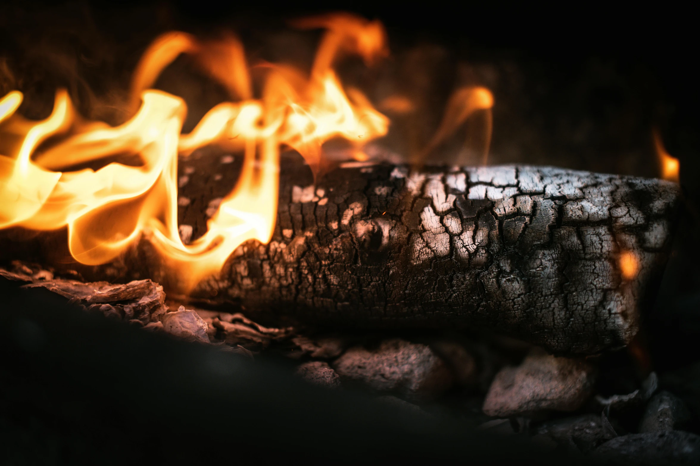 fire that is burning brightly next to rocks