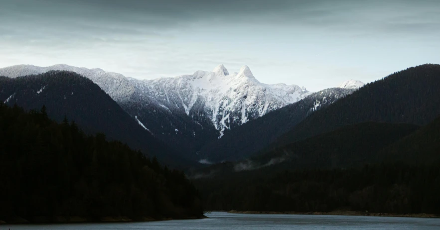 the view of some mountains with water below them