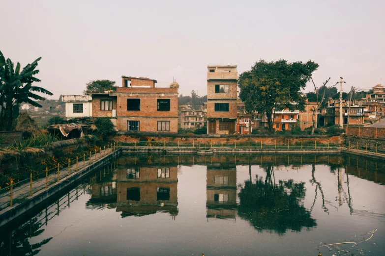 a body of water near some small buildings