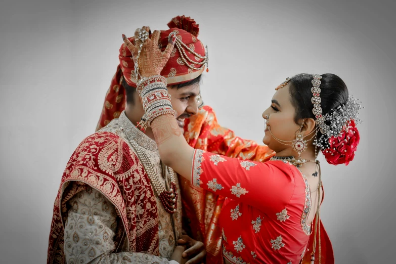 a bride and groom are touching each other