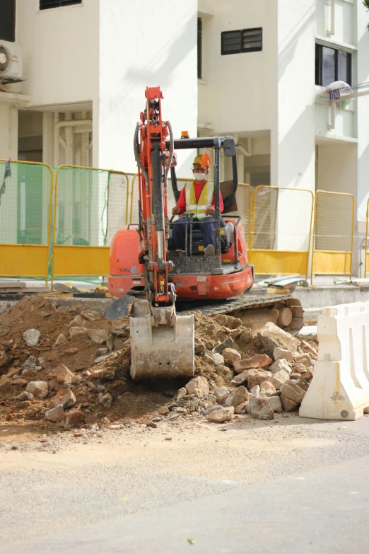 a construction vehicle sits on top of a pile of rocks