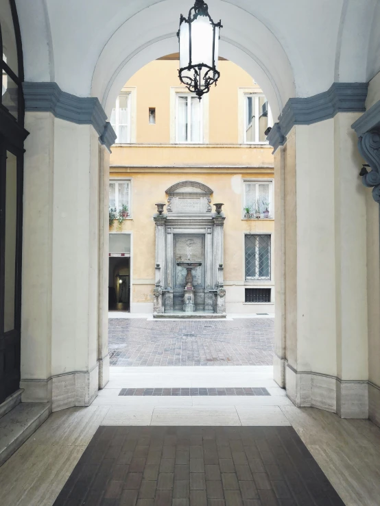 a fountain in the middle of a courtyard in a building