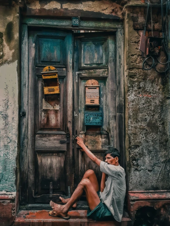 a woman sitting on the steps of a building